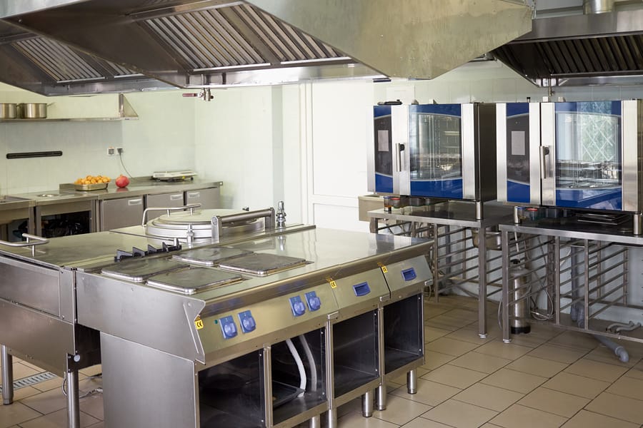 Kitchen room with stoves, sinks and refrigerators in restaurant. Restaurant-Cleaning-Services